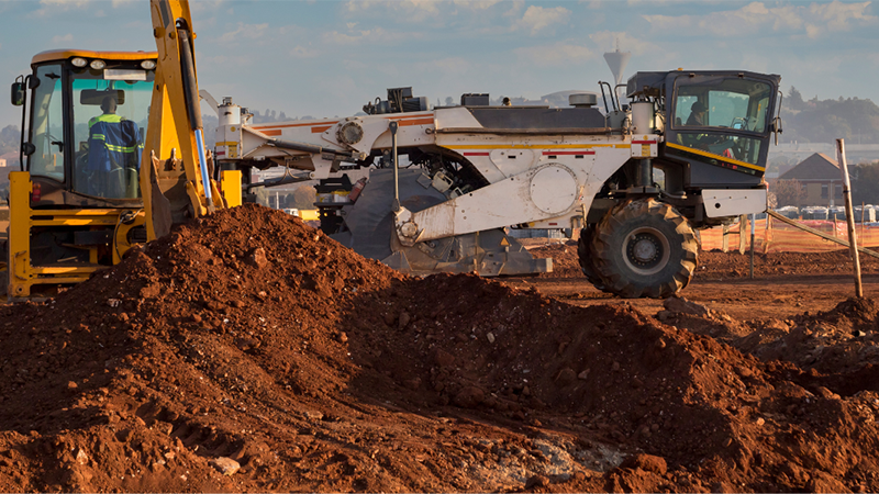 A Construction Site With Heavy Machinery Preparing The Ground For Excavation